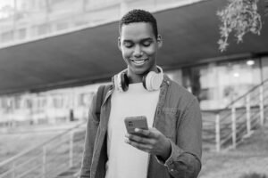 Student athlete communicating with college coaches through twitter and email on their cell phone.