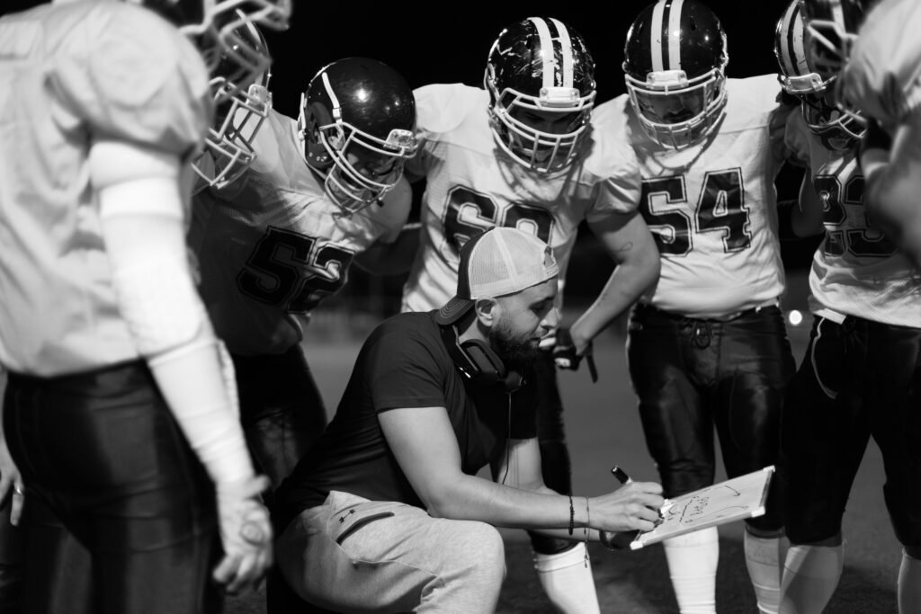 High school football coach who is invested in his team being successful with college sports recruiting.