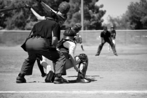 High school athlete competing in a game while being evaluated by college coaches