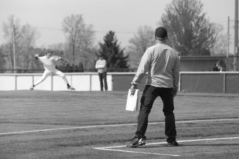Parent watching son play baseball.